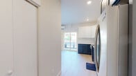 This efficiently designed 440 square foot apartment in Kennewick, WA, offers a blend of style and functionality. The heart of the home is a contemporary kitchen featuring a striking two-tone cabinetry design - pristine white upper cabinets contrasting with deep blue lower cabinets. Stainless steel appliances, including a built-in microwave and dishwasher, complement the modern aesthetic.

The spacious bedroom, measuring 140 square feet, comfortably accommodates a queen-size bed and is brightened by a large window. The full bathroom boasts a shower/tub combination, a vanity with under-sink storage, and is accented with pops of yellow in the towels.

Throughout the apartment, light wood-look flooring creates a warm, cohesive feel. Recessed lighting in the kitchen and living areas adds to the bright, airy ambiance. A sliding glass door in the main living area provides natural light and outdoor access.

The open-concept layout maximizes the use of space, with the kitchen flowing seamlessly into the living area. Despite its compact size, the apartment includes a closet for additional storage. The overall design emphasizes clean lines and a neutral color palette, creating a modern and inviting living space.