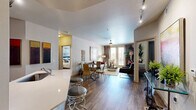 Located at 1 N Hearthstone Way in Chandler, Arizona, this single-floor, 2-bedroom, 2-bathroom residence offers a thoughtfully designed layout with contemporary finishes throughout. Wood-style flooring flows seamlessly across all living areas, tying the space together with warmth and cohesion.

The open-concept kitchen is a standout feature, showcasing dark cabinetry with sleek hardware, light countertops, a white subway tile backsplash, and a full suite of stainless steel appliances including a range, microwave, and refrigerator. Ample cabinet storage and a dishwasher add to its functionality.

The living room is bright and inviting, with a ceiling fan, large windows dressed in floor-length drapes, and a sliding glass door that allows natural light to pour in. The primary bedroom offers a comfortable, well-proportioned retreat with a ceiling fan and dedicated closet space. The second bedroom is equally versatile. Both bathrooms feature dark vanity cabinetry with light countertops, matching the kitchen's design language, along with tub-shower combinations.

A dedicated laundry room houses a full-size washer and dryer alongside an in-unit water heater and open shelving for storage. Two closets provide additional organization throughout the residence, making this a practical and stylish home in the heart of Chandler.