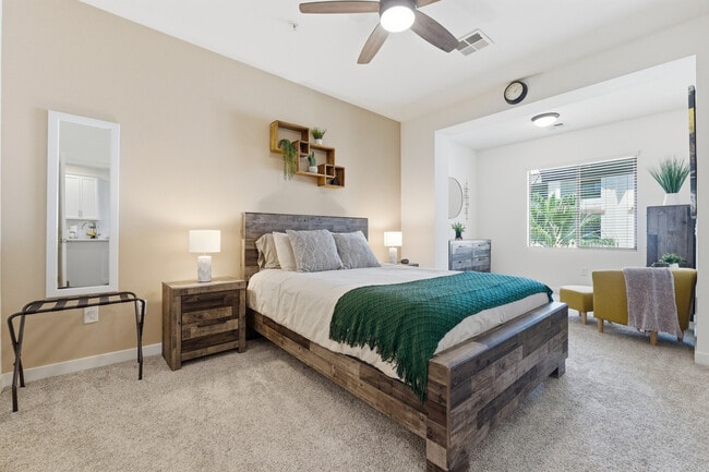 Spacious primary suite with plush bedding and thoughtful touches. - 2511 W Queen Creek Rd