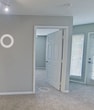 This contemporary 1,160 square foot residence in Sarasota, Florida, offers a well-designed single-story layout with three bedrooms and two bathrooms. The heart of the home is an open-concept living area that seamlessly integrates the kitchen and living room, creating a spacious and inviting atmosphere. The kitchen boasts modern appliances, ample cabinetry in a warm wood tone, and sleek countertops, with a convenient breakfast bar for casual dining.

Throughout the home, a neutral color palette of soft greys and whites creates a calm and versatile backdrop. The bedrooms are generously sized, with the primary bedroom measuring 180 square feet. All bedrooms feature plush carpeting and are equipped with ceiling fans for comfort. Large windows in each room allow for ample natural light, while horizontal blinds offer privacy control.

The bathrooms are designed with functionality in mind, featuring granite countertops, wood vanities, and a combination of tile and wood-look flooring. The residence also includes a dedicated closet space for additional storage. The overall ambiance is one of modern comfort, with clean lines and a bright, airy feel throughout the entire 1,160 square feet of living space.