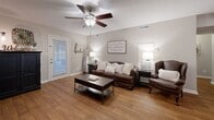 Located at 1250 5th St NE in Hickory, NC, this well-appointed 2-bedroom, 2-bathroom single-floor home offers a comfortable and efficiently designed layout. The living room sets a welcoming tone with warm hardwood flooring, neutral gray walls, a ceiling fan, and natural light filtering through blinds — a versatile space ideal for relaxing or entertaining. The kitchen features warm wood cabinetry, a double stainless steel sink, a stone tile backsplash, and a window that brings in natural light, creating a functional and charming cooking space. The spacious primary bedroom is finished with plush carpet, a ceiling fan, and an expansive wall of louvered bi-fold closet doors offering generous storage. The second bedroom also features carpet, a ceiling fan, dual closet storage, and a window for natural light. Both bathrooms are tastefully appointed — one with a framed vanity mirror and wood cabinetry, and the other with a striped shower curtain and charming décor accents. A hallway connects the rooms with ease, and the patio provides an outdoor retreat. Throughout the home, a consistent warm and neutral palette creates a cozy, move-in-ready atmosphere.