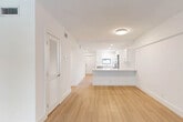 Located at 1361 S Federal Hwy in Boca Raton, FL, this thoughtfully designed 2-bedroom, 2-bathroom residence offers a clean, modern aesthetic throughout its well-proportioned single-floor layout. Light wood flooring flows seamlessly through every room, complementing the crisp white walls and creating a bright, cohesive atmosphere.

The open-concept living area connects directly to the kitchen, which serves as a functional centerpiece of the home. The kitchen features white shaker-style cabinetry, white quartz countertops, a subway tile backsplash, and a full suite of stainless steel appliances including a refrigerator with ice maker, range, microwave, and dishwasher. A peninsula counter provides additional prep space and casual seating, while a window above the sink brings in natural light.

The spacious primary bedroom includes a large window with outdoor views of lush greenery, offering a calm retreat. The second bedroom features sliding glass doors that open to an exterior view, adding an airy quality to the space. Both rooms are finished with the same light wood flooring and neutral tones found throughout. The bathrooms are finished in clean white tile, including a full soaking tub with shower combination. A hallway with a louvered closet door provides practical storage. Recessed lighting throughout enhances the home's modern, polished feel.