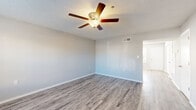 Located at 3000 Fountainhead Circle in Melbourne, Florida, this two-story home offers three bedrooms and three bathrooms across two well-proportioned floors. The main level provides a welcoming living area finished with durable wood-look laminate flooring, neutral gray walls, and a ceiling fan with light fixture — creating a clean, airy atmosphere. Natural light filters in through windows, enhancing the open feel of the space.

The kitchen is a standout feature, boasting crisp white shaker-style cabinetry, marble-look countertops, a double-basin sink, and a full suite of stainless steel appliances including a range, microwave, and dishwasher. Wood-look flooring continues seamlessly into this space, tying the main level together cohesively.

The bedrooms are distributed across both floors, with the generously sized primary bedroom offering ample space. Bedrooms feature either soft carpeting or wood-look flooring, ceiling fans, and windows that bring in natural light. Each bathroom is finished in a clean, functional style — one includes a full tub-shower combination with white surround, wood-look flooring, and a vanity with marble-look countertop. Textured ceilings are present throughout. The exterior is surrounded by mature trees, adding greenery and privacy to the property.