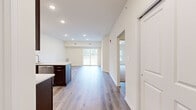 Located at 80 Cypress St, this single-floor unit features a clean, modern design with a well-thought-out open-concept layout. The main living and dining area is anchored by durable hardwood-style flooring and recessed lighting throughout, creating a bright and welcoming atmosphere. A sliding glass door leads to a private balcony, filling the space with natural light and providing views of the surrounding landscape.

The kitchen is a standout feature, equipped with rich dark-espresso cabinetry, light stone countertops, and a full suite of stainless steel appliances, including a refrigerator with ice maker, electric range, and built-in microwave. A peninsula with an integrated sink offers additional prep space and casual seating potential, seamlessly connecting the kitchen to the living area.

A hallway with continued hardwood-style flooring connects to the private areas of the unit. The bedroom features plush neutral carpeting and crisp white walls, providing a comfortable retreat. The bathroom is finished with light tile flooring, a tub and shower combination with a sliding glass enclosure, and clean, minimalist fixtures. Throughout the unit, neutral tones and consistent finishes contribute to a cohesive and move-in-ready aesthetic.