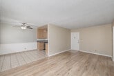 Located at 4315 Don Tomaso Dr in Los Angeles, CA 90008, this single-floor, one-bedroom, one-bathroom unit offers a thoughtfully laid-out living space with a clean, neutral aesthetic throughout. The open living and dining area is bright and welcoming, featuring light wood laminate flooring, warm beige walls, a textured ceiling, and large windows dressed with blinds that allow generous natural light to fill the room. A ceiling fan adds comfort and functionality to the space. The galley-style kitchen is well-equipped, featuring light wood cabinetry, granite countertops, stainless steel appliances including a dishwasher and gas range, a built-in microwave, and tile flooring that transitions seamlessly from the kitchen into the dining area. The spacious bedroom continues the light wood flooring, includes a ceiling fan, a wide window for natural light, and a sliding-door closet with built-in shelving and hanging rods for ample storage. The bathroom is finished in crisp white, offering a single-sink vanity with storage cabinetry, a tiled tub-shower combo with sliding glass doors, and tile flooring. A hallway connects the main living areas, completing this well-organized and move-in-ready Los Angeles residence.