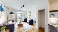 Located at 9051 Seneca Dr in Wilmington, NC, this well-appointed 1-bedroom, 1-bathroom unit offers a thoughtfully designed single-floor layout. The open-concept living room and kitchen serve as the heart of the space, featuring striking polished concrete floors with warm amber tones throughout. The living area is illuminated by a modern track lighting system and opens to an outdoor patio through a glass-paneled door, inviting natural light and outdoor views. The kitchen is fully equipped with stainless steel appliances, including a full-size refrigerator, range, and over-the-range microwave, complemented by grey shaker cabinetry, white subway tile backsplash, granite countertops, and a compact dining area. The bedroom is a comfortable retreat with multiple windows providing ample natural light, a ceiling fan, and a dedicated closet. The bathroom features a walk-in shower and built-in open wood shelving for storage. A dedicated laundry area with a full-size washer and dryer adds everyday convenience. A separate nook off the kitchen provides an ideal workspace. The unit's cohesive design, combining modern fixtures with warm flooring, creates a clean and functional living environment.