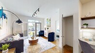 Located at 9051 Seneca Dr in Wilmington, NC, this well-appointed 1-bedroom, 1-bathroom unit offers a thoughtfully designed single-floor layout. The open-concept living room and kitchen serve as the heart of the space, featuring striking polished concrete floors with warm amber tones throughout. The living area is illuminated by a modern track lighting system and opens to an outdoor patio through a glass-paneled door, inviting natural light and outdoor views. The kitchen is fully equipped with stainless steel appliances, including a full-size refrigerator, range, and over-the-range microwave, complemented by grey shaker cabinetry, white subway tile backsplash, granite countertops, and a compact dining area. The bedroom is a comfortable retreat with multiple windows providing ample natural light, a ceiling fan, and a dedicated closet. The bathroom features a walk-in shower and built-in open wood shelving for storage. A dedicated laundry area with a full-size washer and dryer adds everyday convenience. A separate nook off the kitchen provides an ideal workspace. The unit's cohesive design, combining modern fixtures with warm flooring, creates a clean and functional living environment.