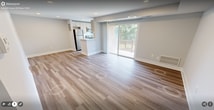 This 630 square foot apartment in Alexandria, VA, offers a blend of modern design and functional living space. The open-concept floor plan seamlessly integrates the living room and kitchen, creating a spacious feel enhanced by recessed lighting and light-toned walls. The kitchen boasts sleek white cabinetry, stainless steel appliances, and a subway tile backsplash, perfect for culinary enthusiasts.

The primary bedroom, measuring 240 square feet, features plush carpeting and a large window, allowing natural light to flood the space. A sliding glass door provides access to a private balcony, offering outdoor views and fresh air. The room is complemented by a sizeable closet with white bi-fold doors, ensuring ample storage.

Throughout the apartment, warm-toned laminate flooring adds a touch of elegance and continuity. The hallway connects the various spaces efficiently, while the bathroom (not pictured) likely maintains the same modern aesthetic found throughout the home.

The property's single-floor layout and thoughtful design make it an ideal choice for those seeking a contemporary living space in a convenient Alexandria location. The combination of functionality and style creates a welcoming atmosphere perfect for both relaxation and entertaining.