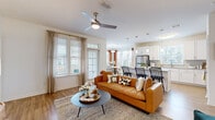 Located at 485 Crafton Cir in Charlottesville, VA, this well-appointed 2-bedroom, 2-bathroom single-floor home offers a thoughtfully designed open-concept layout. The living room is bright and welcoming, featuring hardwood-style flooring, a ceiling fan, and large windows dressed with elegant curtains that fill the space with natural light. It flows seamlessly into the dedicated dining area, which is surrounded by windows and anchored by a round table beneath a modern pendant light. The kitchen is a standout feature, boasting white shaker cabinetry, a granite-topped island with bar seating, subway tile backsplash, stainless steel appliances, and pendant lighting. The primary bedroom offers a comfortable retreat with plush carpeting, a ceiling fan, and generous closet space, complemented by an en-suite bathroom featuring a dual-sink vanity with granite countertops and wood-look flooring. The second bedroom is equally well-sized. Three closets provide ample storage throughout. A dedicated laundry room houses a full-size washer and dryer. With a clean, neutral palette and modern finishes, this home delivers a bright and functional living experience in a prime Charlottesville location.