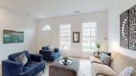 Located at 200 W Main St in New Albany, Ohio, this two-story home offers a thoughtfully designed layout with clean, modern finishes throughout. The main level welcomes visitors through a charming arched entry door into a sun-filled living room, where large double-hung windows flood the space with natural light. Light-toned hardwood flooring and crisp white walls create a bright, airy atmosphere, while a classic white staircase connects the two floors with timeless elegance.

The kitchen is well-appointed with gray shaker-style cabinetry, white quartz countertops, a subway tile backsplash, and a full suite of stainless steel GE appliances, including a double oven range, microwave, dishwasher, and side-by-side refrigerator. A double-basin sink sits beneath a window overlooking the outdoors.

Upstairs, the bedrooms offer comfortable retreats with plush carpeting and generous natural light. One bedroom features a walk-in closet with built-in wire shelving, while another includes a sliding double-panel closet. A full bathroom on the upper level features marble-look tile flooring, a vanity with ample storage, and a tub-shower combination. The spacious walk-in closet with multi-tiered wire shelving provides exceptional storage capacity, completing this well-organized and inviting home.