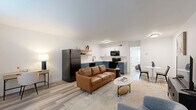 This 560 square foot home in Fayetteville, Arkansas, offers a modern and efficient living space. The property features two bedrooms and one bathroom, all on a single floor. The kitchen is a standout with its contemporary design, showcasing blue lower cabinets contrasted with white upper cabinets and a sleek white backsplash. Stainless steel appliances and floating wooden shelves add both functionality and style.

The living area adopts an open-concept layout, seamlessly connecting to the kitchen. It boasts wood-look flooring, contemporary furniture, and artistic wall decor that adds character to the space. The bathroom, while compact, is well-appointed with a white vanity, modern fixtures, and a shower/tub combination.

The primary bedroom, measuring 160 square feet, features a ceiling fan, large window for natural light, and ample space for a queen-sized bed. The second bedroom, which could double as an office or guest room, also benefits from natural light and the continuation of the wood-look flooring.

Additional amenities include in-unit laundry facilities and built-in storage solutions. Throughout the home, the neutral color palette and modern finishes create a cohesive and inviting atmosphere, making efficient use of the compact 560 square foot layout.
