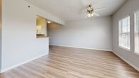 Located at 1812 Caroline Ave in Junction City, Kansas, this single-floor, one-bedroom, one-bathroom home offers a clean, functional layout with thoughtful finishes throughout. The open living room is finished with light hardwood-style flooring that reflects natural light pouring in through multiple windows fitted with blinds. A ceiling fan adds both comfort and style to the space, while a door with a window panel provides direct outdoor access. The living area flows seamlessly to a kitchen pass-through counter, where white cabinetry and built-in appliances are visible, creating an efficient and connected layout. The bedroom features soft carpet flooring, a ceiling fan with light fixture, and a bright window with outdoor views, offering a comfortable and restful retreat. A dedicated closet provides convenient storage. The bathroom is well-equipped with a vanity featuring a warm-toned countertop, white cabinetry, a large mirror, and a glass-door shower enclosure. The in-unit laundry room includes a full-size washer and dryer with overhead wire shelving for added storage. Throughout, neutral gray walls and clean white trim create a cohesive and move-in-ready aesthetic.