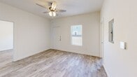 Located at 3040 W Washington St in Stephenville, TX, this single-story, 3-bedroom, 3-bathroom home offers a thoughtfully designed layout that maximizes every inch of its compact footprint. Light wood-look flooring flows consistently throughout the home, lending a cohesive and clean aesthetic to each room. The open living, dining, and kitchen area serves as the heart of the home, featuring a ceiling fan with light fixture and a cassette-style HVAC unit for year-round comfort. The kitchen is well-appointed with gray shaker-style cabinetry, dark granite countertops, a stainless steel refrigerator, range, and dishwasher, plus under-cabinet lighting and a window for natural light. Each of the three bedrooms is bright and neatly finished with neutral walls, ceiling fans, and windows that bring in natural light. Four closets are distributed throughout the home, providing ample storage. The three bathrooms are uniformly designed with gray vanities, dark countertops, brushed nickel hardware, and tub-shower combinations with white surrounds. A dedicated laundry area adds everyday convenience. The home's clean, modern interior and practical layout make it an efficient and comfortable living space.