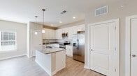 Located at 7011 Star Oaks Ln in Charlotte, NC, this well-appointed one-bedroom, one-bathroom residence offers a thoughtfully designed single-floor layout. The open-concept kitchen and living area forms the heart of the home, showcasing white shaker cabinetry, granite countertops, a central island with a built-in sink, and a full suite of stainless steel appliances including a refrigerator with ice maker, electric range, and over-the-range microwave. Light wood-style flooring flows throughout the main living areas, complementing the neutral, warm-toned walls and recessed lighting overhead. The living room is bright and airy, with a ceiling fan, sliding glass door access to one of two balconies, and ample natural light. The bedroom features plush carpeting, a ceiling fan, a double-door closet, and windows with blinds. The full bathroom includes a soaking tub and shower combination alongside a linen closet with built-in shelving. Additional highlights include a dedicated entrance, in-unit laundry, and multiple closets for generous storage. The clean, modern aesthetic and efficient layout make this a comfortable and functional Charlotte residence.
