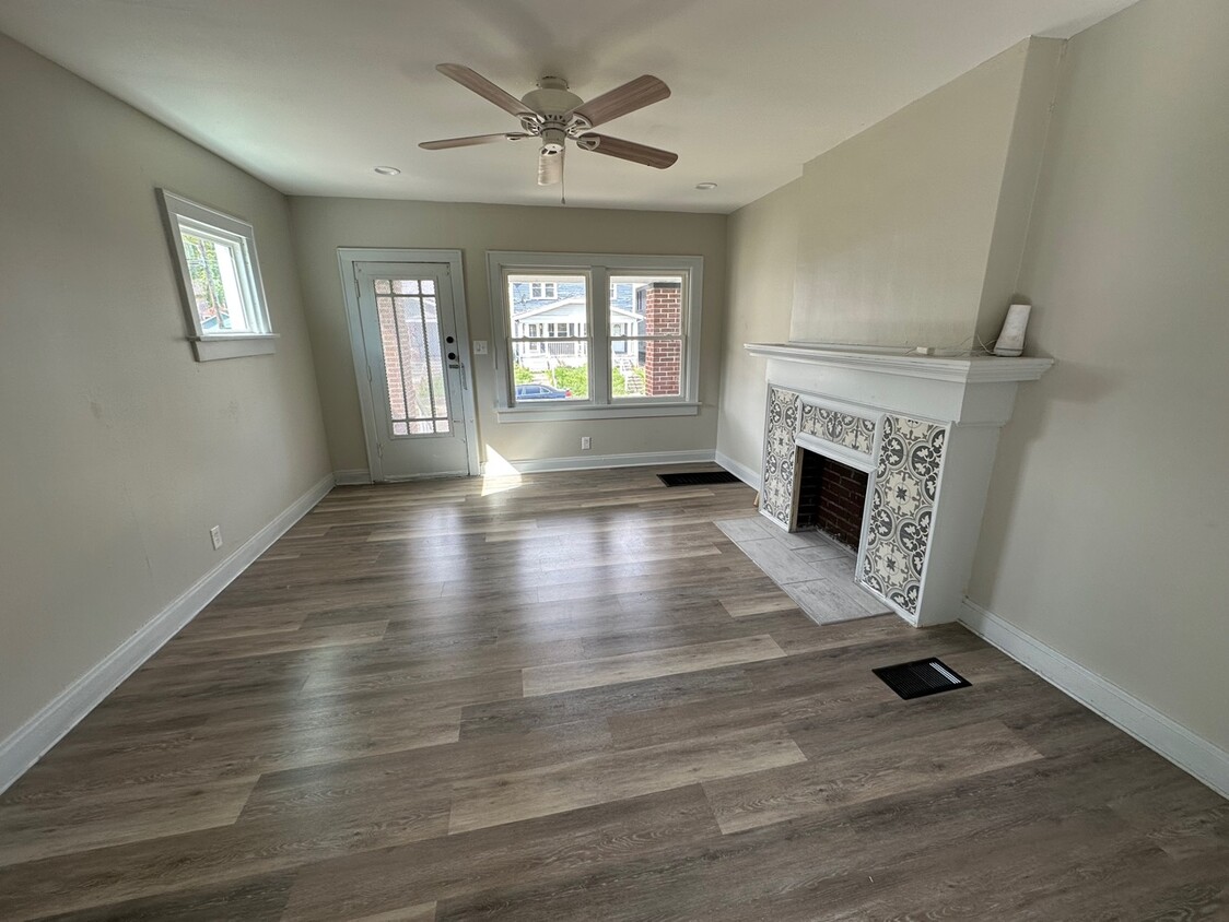 Living room entrance with beautifully tiled fireplace with marble flooring. - 738 Seymour Ave