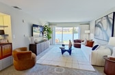 This 950 square foot apartment in Schaumburg, Illinois, offers a well-designed living space with two bedrooms and three bathrooms. The single-floor layout maximizes functionality, with the primary bedroom measuring a generous 180 square feet. The living room is a highlight, featuring large windows that frame picturesque lake views, creating a serene atmosphere. Modern furnishings and contemporary artwork throughout add a stylish touch to the space.

The kitchen boasts wooden cabinetry, stainless steel appliances, and a practical L-shaped design. In-unit laundry facilities provide added convenience. The bedrooms are well-appointed with comfortable bedding and artistic decor, while the bathrooms feature clean, white tiling and modern fixtures.

The apartment's neutral color palette, complemented by pops of color in the artwork and furnishings, creates a cohesive and inviting ambiance. Carpeting in the living areas and bedrooms adds warmth, while the kitchen's wood flooring offers a durable, easy-to-clean surface. This thoughtfully designed space efficiently accommodates modern living needs within its compact footprint.