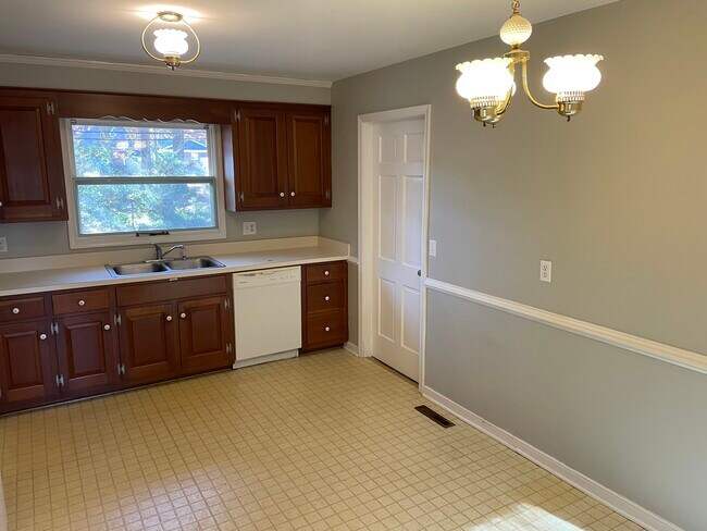 Cocina con lavadero/cuarto de servicio a través de la puerta. - 202 Norwood Dr
