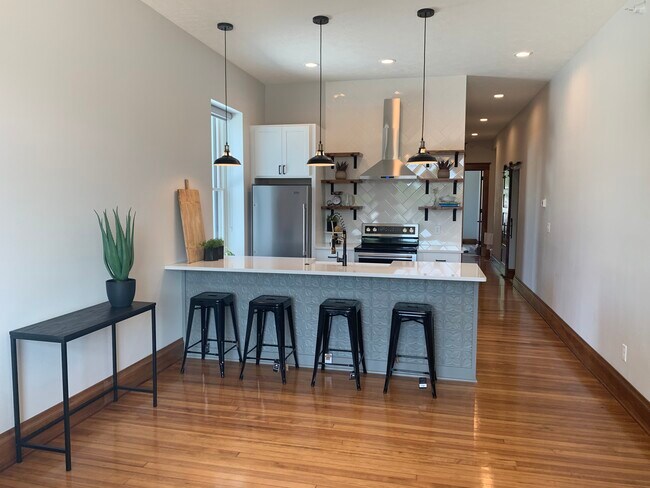 Stunning kitchen showcasing the repurposed tin ceiling from the White House Bathing Palace. - 218 Central Ave NE