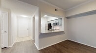 Located at 540 Carillon Pkwy in Saint Petersburg, Florida, this single-floor residence offers a thoughtfully designed layout with contemporary finishes throughout. The kitchen is a standout feature, outfitted with gray shaker-style cabinetry, granite countertops, a subway tile backsplash, and a full suite of stainless steel appliances including a range, microwave, and dishwasher. A peninsula with a built-in sink provides additional prep space and opens directly to the living and dining areas, creating a connected, open-concept flow. Dark hardwood-style flooring runs throughout the main living spaces, offering a warm and cohesive aesthetic. Crown molding adds a refined architectural detail to the living area, which features a large sliding glass door fitted with vertical blinds, allowing for abundant natural light and outdoor access. Additional rooms include well-proportioned bedrooms with windows that bring in natural light, ceiling fans, and the same rich flooring. The entryway is finished with light tile flooring, providing a clean transition into the home. The textured ceilings and neutral wall tones create a bright, versatile backdrop suited to a variety of interior styles.