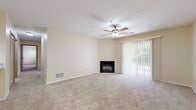 Located at 442 Danbury Ct in Copley, Ohio, this single-floor residence offers a well-organized layout with a bright, neutral palette throughout. The spacious living room is a standout feature, showcasing plush carpeting, a ceiling fan with light fixture, a corner fireplace, and a full-length sliding glass door with vertical blinds that allows ample natural light and outdoor access. The kitchen is efficiently designed in a galley style and opens to the living area via a peninsula with granite countertops and an integrated sink. White cabinetry lines the walls, complemented by stainless steel appliances including a refrigerator, range, microwave, and dishwasher, with stone-tile flooring completing the space. The bedrooms are generously sized, each featuring soft carpeting and large windows that frame views of the surrounding greenery, providing a calm, nature-connected atmosphere. Closet space is included in the bedroom areas. The bathrooms feature stone-tile flooring, full tub-shower combinations, and clean white fixtures, with one bathroom offering a vanity with cabinet storage. Overall, the residence presents a functional and comfortable living environment with consistent finishes throughout.