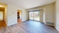 Located at 208 Middleway Rd, Unit 3D in Middle River, MD, this one-bedroom, one-bathroom residence offers a well-organized single-floor layout designed for comfortable everyday living. Light-toned wood-look flooring flows consistently throughout the entire unit, creating a cohesive and clean aesthetic from room to room.

The kitchen is a functional highlight of the home, featuring rich dark-brown cabinetry with ample upper and lower storage, light granite-style countertops, and a full suite of stainless steel appliances including a gas range, microwave, dishwasher, and refrigerator. The open layout allows the kitchen to connect naturally to the living area, enhancing the sense of space.

The living room is bright and welcoming, bathed in natural light from large sliding glass doors that open to a private balcony with outdoor views of the surrounding community. A closet with louvered doors adds convenient storage directly off the living area.

The bedroom is a comfortable retreat with a window that brings in natural light, neutral walls, and direct access to a closet and hallway. The bathroom is finished with classic white subway tile surrounding a full soaking tub and shower combination, complemented by clean white fixtures throughout. The unit's neutral palette and consistent flooring make it a versatile and move-in ready space.