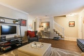 This two-floor residence in Atlanta, Georgia offers a thoughtfully designed layout across multiple rooms, each finished with attention to detail. The formal dining room is a standout, featuring rich hardwood flooring, elegant crown molding, a wainscoted accent wall, and an arched entryway. A pendant light anchors the space, while sliding glass doors open to an outdoor area, filling the room with natural light and garden views.

The living room exudes warmth and comfort, with crown molding, carpet flooring, and generous space for seating arrangements. It connects seamlessly to the dining area, creating a natural flow ideal for entertaining.

The kitchen is well-equipped with warm oak cabinetry, a tile backsplash, light countertops, and stainless steel appliances, including a gas range — providing ample storage and functionality.

The bedrooms are carpeted and comfortable, each offering closet storage and natural light through curtained windows. The primary bedroom is notably spacious. Bathrooms feature wood-look flooring, white cabinetry with brushed nickel hardware, extended vanity countertops, and a walk-in shower. A convenient half bath is also present.

Neutral tones, textured ceilings, and consistent trim work throughout lend the space a cohesive and welcoming ambiance.
