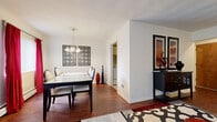 Located at 250 Milford St in Rochester, NY, this two-bedroom, one-bathroom home offers a practical and well-organized single-floor layout. The combined living and dining area forms the heart of the home, featuring rich hardwood flooring that adds warmth throughout. The dining space is illuminated by a classic chandelier and benefits from natural light through windows dressed with vertical blinds. The living room provides a cozy retreat with a large window allowing ample natural light to fill the space. The kitchen is equipped with white appliances including a refrigerator and dishwasher, oak-trimmed cabinetry, a stainless steel sink, and tile flooring, offering a functional workspace. The primary bedroom is generously proportioned, while the second bedroom features carpeted flooring, a window with natural views, and comfortable dimensions suitable for various uses. The bathroom includes a full soaking tub with white subway tile surround and mosaic tile flooring, combining classic design with everyday functionality. In-unit laundry hookups are also visible, adding convenience. Overall, the home presents a clean, neutral palette with hardwood and tile floors throughout the main living areas.