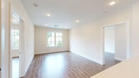 Located at 41 W Prospect St in Waldwick, NJ, this thoughtfully designed single-floor residence offers two bedrooms, two bathrooms, and a well-appointed kitchen within a comfortable and efficiently laid-out floor plan. The open-concept kitchen is a standout feature, showcasing white shaker cabinetry, light quartz countertops, a subway tile backsplash, a peninsula with an undermount sink, and a full suite of stainless steel appliances including a gas range, over-the-range microwave, dishwasher, and refrigerator. Recessed lighting and large windows bathe the kitchen and adjoining living area in natural light, with views of the surrounding neighborhood. Warm hardwood-style flooring flows consistently throughout the living areas and bedrooms, creating a cohesive and inviting atmosphere. The spacious primary bedroom includes its own walk-in closet outfitted with wire shelving systems for ample storage. A second walk-in closet serves the additional bedroom. Both bathrooms are finished with neutral porcelain tile flooring, and one features a glass-enclosed walk-in shower with floor-to-ceiling marble-look tile, chrome fixtures, grab bars, and a white vanity with a quartz countertop. The overall aesthetic is clean, modern, and move-in ready.