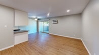 This contemporary 900 square foot residence in Los Alamitos, CA offers a well-designed living space with two bedrooms and two bathrooms. The single-story layout maximizes functionality, featuring an open-concept design that seamlessly integrates the living room and kitchen areas. The primary bedroom, spanning a generous 220 square feet, provides ample space for comfort and relaxation.

Throughout the home, sleek finishes and modern amenities are evident. The kitchen showcases white cabinetry, stainless steel appliances, and quartz countertops, creating a bright and efficient cooking space. Both bathrooms are outfitted with modern fixtures, including stylish vanities and large mirrors.

The living areas and bedrooms boast warm wood-look flooring, adding a touch of warmth to the crisp, neutral color palette. Large windows in the living room and bedrooms allow natural light to flood the space, while ceiling fans and air conditioning units ensure year-round comfort.

Storage solutions are integrated seamlessly, with mirrored sliding closet doors in the bedrooms maximizing space and functionality. The overall design emphasizes clean lines and a minimalist aesthetic, creating a fresh and inviting atmosphere throughout this compact yet well-appointed home.