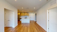 This well-appointed 3-bedroom, 2-bathroom residence at 434 Springfield Ave in Berkeley Heights, NJ offers a thoughtfully designed single-floor layout with modern finishes throughout. The open-concept kitchen and living area serves as the heart of the home, featuring warm hardwood flooring, recessed lighting, and large windows that invite abundant natural light. The kitchen is equipped with a central island with a built-in sink and white quartz countertops, complemented by natural wood cabinetry, a marble-style tile backsplash, stainless steel appliances including a French door refrigerator and built-in microwave, creating a sleek and functional cooking space. The living area flows seamlessly from the kitchen, offering generous room for entertaining. The primary bedroom includes a dedicated closet and direct access to a beautifully finished en-suite bathroom, which features floor-to-ceiling marble-style tile, a glass-enclosed walk-in shower, hexagonal mosaic tile flooring, and a modern vanity. Additional bedrooms are bright and airy, each with hardwood floors and large windows offering views of the surrounding neighborhood. The home also includes a utility room, hallway, and ample closet storage, rounding out a complete and comfortable living environment.