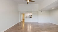 Located in Clearwater, Florida, this single-floor, 2-bedroom, 2-bathroom residence offers a well-designed layout with a bright and airy ambiance throughout. The open living area is highlighted by vaulted ceilings, a ceiling fan, and large windows that invite abundant natural light and views of the surrounding greenery. Durable hardwood-style flooring runs through the main living spaces, adding warmth and a modern aesthetic.

The kitchen is designed for functionality, featuring a galley-style layout with white cabinetry, quartz countertops, a subway tile backsplash, and a full suite of stainless steel appliances including a range, microwave, refrigerator, and dishwasher. A convenient pass-through counter connects the kitchen to the living area, enhancing the open feel.

Both bedrooms are comfortably sized, finished with plush carpeting, ceiling fans, and windows overlooking lush tropical foliage. Each room includes closet storage, with three closets total throughout the unit. The two bathrooms are clean and well-appointed, each featuring a tub-shower combination, quartz-topped vanities, white cabinetry, and tiled surrounds. Two hallways provide efficient circulation between the home's rooms, completing this practical and welcoming Clearwater residence.