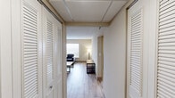 Located at 2521 Kingston Pike in Knoxville, TN, this 2-bedroom, 1-bathroom unit offers a practical and well-organized single-floor layout. Light wood-style flooring runs throughout, creating a cohesive and clean aesthetic across all rooms. The open-concept living and kitchen area forms the heart of the unit, where a comfortable seating arrangement flows naturally into a compact kitchen equipped with stainless steel appliances, including a refrigerator, gas range, and microwave. Dark cabinetry and a granite-style countertop with bar seating add a functional and stylish touch to the kitchen space. Windows in the living area allow natural light to fill the room and provide outdoor views. The primary bedroom offers a spacious layout with a window overlooking the exterior, providing natural light and outdoor views, complemented by light neutral walls and light wood flooring. The second bedroom is more compact but equally functional, featuring similar finishes. The shared full bathroom includes a tiled tub-shower combination, a granite-top vanity with wood cabinetry, and light wood flooring, finished with a drop ceiling. Neutral wall tones and textured ceilings throughout contribute to a simple, functional ambiance suited for everyday living.