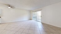 Located at 630 Haward Ave in Montebello, California, this two-bedroom, one-bathroom residence offers a well-organized single-floor layout with a practical and clean design throughout. The open living room is finished with light tile flooring set in a diagonal pattern and features a textured ceiling, neutral walls, and a sliding glass door that opens to a private balcony, bringing in natural light and outdoor access. The kitchen is efficiently laid out with white cabinetry, dark granite-style countertops, tile flooring, a white electric range, and a double-basin sink — providing all the essentials in a compact, functional space. The bathroom features a wide vanity with matching dark countertops, white cabinetry, and tile flooring, with an open view toward the balcony area. Both bedrooms are carpeted in a warm mauve tone with neutral walls and clean white trim. The primary bedroom is generously sized and benefits from a window with vertical blinds that allows natural light to filter in. A dedicated walk-in closet serves the unit, complete with built-in shelving and hanging rods on tile flooring, offering organized and ample storage. The overall aesthetic is clean, neutral, and move-in ready.