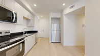 Located at 433 Rosenell Terr in the Silver Lake neighborhood of Los Angeles, CA, this modern 2-bedroom, 2-bathroom unit offers a clean, contemporary design with consistent light wood flooring and a neutral color palette throughout. The kitchen is well-appointed with white shaker cabinets, dark granite countertops, stainless steel appliances including a range, microwave, dishwasher, and full-size refrigerator, all set against a bright, open layout that flows toward the entry. Both bedrooms are bright and airy, each featuring large windows with vertical blinds that allow ample natural light. The primary bedroom includes a mirrored sliding closet, adding a sense of depth and practicality. The two bathrooms are finished consistently with white cabinetry, dark granite vanity tops, undermount sinks, and full tub-shower combinations with white tile surrounds. One bathroom features built-in open shelving for added storage convenience. Recessed lighting throughout enhances the clean, modern aesthetic. A hallway and dedicated closet round out the thoughtfully organized floor plan, making efficient use of the available space while maintaining a comfortable and polished living environment.