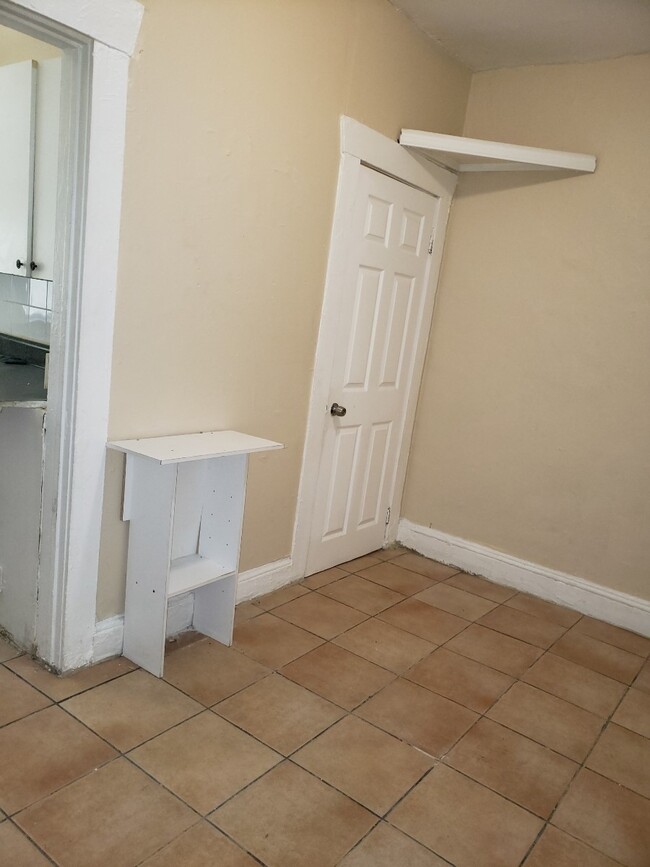 Living space with door to bathroom - 2110 W Flagler St