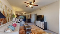 Located at 14600 N Rockwell Ave in Oklahoma City, OK, this well-appointed 2-bedroom, 3-bathroom home offers a smart, functional layout across a single floor. The open-concept living and dining area serves as the heart of the home, featuring plush carpet, ceiling fans with light fixtures, and large windows that invite natural light. The kitchen is outfitted with rich dark wood cabinetry, granite-style countertops, a breakfast bar with seating, black appliances including a refrigerator and range, and wood-look flooring that extends into the dining space — ideal for both everyday living and entertaining. The spacious primary bedroom features vaulted ceilings, a ceiling fan, plush carpet, and a large window providing ample natural light, complemented by a generous walk-in closet with multi-tier shelving. The second bedroom is equally comfortable, also featuring carpet and a ceiling fan. Each of the three bathrooms is finished with dark wood vanities, white countertops, framed mirrors, and stylish fixtures. A connecting hallway ties the layout together efficiently, offering easy access to all rooms. The overall ambiance is warm and inviting, with a cohesive design throughout.