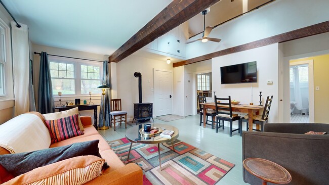 Open living/dinning room with gas fired woodstove - 65 Ohayo Mountain Rd