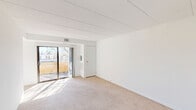 Located at 779 Eves Dr in Hillsborough, NJ, this single-floor, one-bedroom, one-bathroom residence offers a well-organized and efficient layout throughout. The bright living room is finished with neutral wall-to-wall carpeting and features sliding glass doors that flood the space with natural light and open directly onto a private balcony, providing pleasant outdoor views. Adjacent to the living room, the dedicated dining area is accented by a classic chain-hung chandelier and a large window dressed with vertical blinds, creating a comfortable space for everyday dining. The kitchen is thoughtfully appointed with white cabinetry, dark laminate countertops, a stainless steel sink, and a striking black-and-white mosaic tile backsplash that adds a decorative touch. In-unit laundry is conveniently integrated into the kitchen area. The spacious primary bedroom features soft carpeting and is complemented by generous closet space, including a walk-in closet. Two additional closets throughout the residence further enhance storage options. The full bathroom includes a clean, white tub-shower combination with chrome fixtures. Crisp white walls and consistent neutral carpeting throughout give the residence a clean, move-in-ready feel.