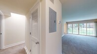This 900 square foot one-bedroom apartment in Newport Village offers a harmonious blend of comfort and contemporary design. The open-concept floor plan creates a sense of spaciousness, with the living area seamlessly connecting to the kitchen. Large windows flood the space with natural light, enhancing the airy atmosphere.

The kitchen is a standout feature, boasting modern wood cabinetry, granite countertops, and stainless steel appliances. A central island with pendant lighting serves as both a functional workspace and a casual dining area. The adjacent living room is generously sized, perfect for relaxation or entertaining.

The bedroom, measuring 200 square feet, provides ample space for a king-sized bed and additional furniture. It features plush carpeting and windows that offer pleasant views and natural illumination. A closet offers convenient storage solutions.

The bathroom is well-appointed with a large bathtub, modern fixtures, and tiled walls. Throughout the apartment, neutral tones create a calming ambiance, while the carpeted floors in the living areas and bedroom add warmth and comfort.

This apartment combines style and functionality, making it an ideal home for those seeking a modern living space in a desirable location.