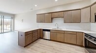Located at 6152 Carlson Way in Marion, Iowa, this thoughtfully designed one-bedroom, one-bathroom unit offers a efficient and modern living experience across a single floor. The open-concept kitchen is a standout feature, showcasing warm medium-toned wood cabinetry with sleek bar-pull hardware, crisp white quartz countertops, and a classic white subway tile backsplash. A full suite of stainless steel appliances — including a French door refrigerator with ice maker, electric range, built-in microwave, and dishwasher — completes the space. Light hardwood-style flooring flows seamlessly throughout, complementing the neutral color palette and recessed lighting overhead. The kitchen also benefits from a peninsula that provides additional counter space and storage. The bedroom offers a cozy footprint with a window that brings in natural light and views of the surrounding community. A dedicated closet provides practical storage. The bathroom is clean and functional, featuring a wood-toned vanity with a white countertop, a full tub/shower combination, and consistent finishes that tie the unit together. The 3D floorplan reveals a well-organized layout that maximizes every square foot of this inviting Marion residence.