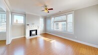 Located at 204 Tacoma Ave S, this well-appointed single-floor, 3-bedroom, 2-bathroom home offers a thoughtfully designed layout with classic architectural character throughout. Warm hardwood flooring flows consistently across the living areas, hallways, and bedrooms, tying the home together with a cohesive, inviting aesthetic.

The main living room is a standout space, featuring a white-mantled fireplace with a tile hearth, crown molding, a ceiling fan, and large windows that flood the room with natural light while framing views of the surrounding Tacoma cityscape. A second living area provides additional flexibility for use as a formal sitting room or office.

The kitchen is bright and functional, offering white cabinetry, a double basin sink, a dishwasher, and three windows that bring in generous natural light and city views. Built-in shelving and cabinetry add storage and character to the adjacent dining or flex space.

Each of the three bedrooms is well-sized, with the spacious primary bedroom offering ample room and closet access. The additional bedrooms feature louvered bifold closet doors. Two bathrooms serve the home — one with a shower-tub combo and white vanity, the other with a standalone glass-enclosed shower. Connected hallways provide a smooth, navigable flow throughout the home.