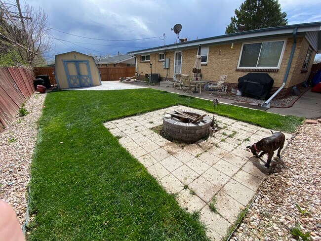 Spacious backyard with a firepit and large shed - 7960 Hooker St
