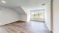 Located at 938 E 4th St in Bethlehem, PA, this two-bedroom, one-bathroom unit offers a thoughtfully designed layout with a blend of modern finishes and comfortable living spaces. The open-concept kitchen and living area serves as the heart of the home, showcasing bold granite countertops with dramatic veining, a central island with a sink, gray shaker-style cabinetry, a marble-inspired tile backsplash, and a full suite of stainless steel appliances. Light hardwood-style flooring runs throughout the main living areas, complemented by large windows that flood the space with natural light and offer sweeping views of the Bethlehem skyline and surrounding neighborhood. Distinctive angled ceilings add architectural character to both the living area and the primary bedroom, which features hardwood-style flooring and expansive windows with scenic vistas. The second bedroom is carpeted and includes a closet, providing a cozy, functional space. Both bedrooms benefit from ample closet storage, with four closets total throughout the unit. The bathroom features a clean white palette with a tub-shower combination and striking geometric-patterned tile flooring. A dedicated dining area and hallway complete the well-organized floor plan, making this a polished and practical urban residence.