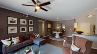 Located in Littleton, Colorado, this single-floor residence offers a thoughtfully designed layout that balances comfort and functionality. The open-concept living and dining area serves as the heart of the home, featuring rich hardwood-style flooring, crown molding, and a ceiling fan overhead. Deep taupe accent walls provide a warm backdrop, while a sliding glass door in the living area fills the space with natural light and provides access to an outdoor patio. The dining area transitions seamlessly from the living space, creating an inviting flow throughout.

The kitchen is equipped with stainless steel appliances, including a range, microwave, and refrigerator, complemented by white cabinetry, neutral countertops, and a undermount sink. Hardwood-style flooring continues throughout, adding visual continuity.

The bedrooms are generously sized, each featuring ceiling fans, large windows, and walk-in closets with built-in shelving for ample storage. One bedroom showcases a bold accent wall, adding a distinctive design touch.

The bathrooms are finished with white cabinetry, dark countertops, hardwood-style flooring, and tub-shower combinations. A spacious walk-in closet with multi-tier shelving and hanging rods adds notable storage capacity to the primary bedroom suite.