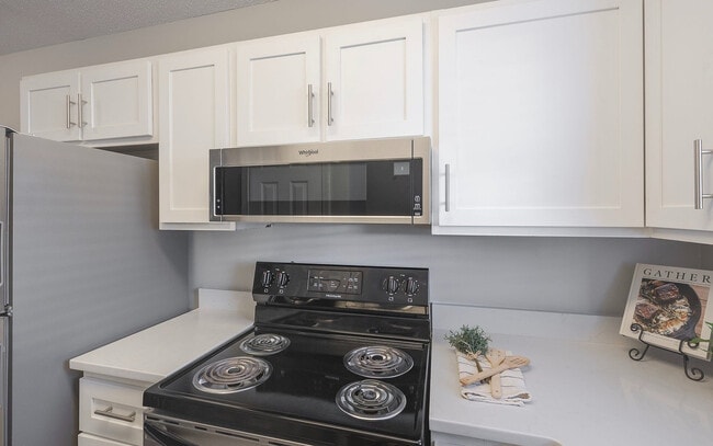 Stainless steel appliances paired with clean finishes for a sleek, modern look. - The Alden Townes