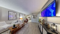 Located at 2301 S Valley View Blvd in Las Vegas, NV, this well-appointed one-bedroom, one-bathroom unit offers a cohesive and contemporary design throughout its efficiently utilized floor plan. Light wood-style flooring runs throughout, lending a clean and consistent aesthetic to every room.

The open living area is a standout feature, offering generous space for both relaxing and entertaining. A wall-mounted flat-screen TV anchors one end of the room, complemented by a sleek media console, decorative mirrors, and curated artwork that adds warmth and character. The living area flows naturally toward a compact dining nook adjacent to the kitchen.

The kitchen is outfitted with white cabinetry, granite-style countertops, a subway tile backsplash, and stainless steel appliances including a full-size refrigerator and range. A ceiling fan keeps the space comfortable.

The bedroom is a calm retreat, featuring a window with white drape panels that allow natural light while maintaining privacy. A textured ceiling, wood-style flooring, and tasteful décor complete the room alongside a dedicated closet for storage.

The bathroom features a white vanity with granite-style countertops, a tub/shower combination, and neutral finishes that give it a clean, functional look. The overall ambiance throughout the unit is modern, warm, and move-in ready.