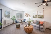 Located at 1700 Broadway St in Concord, CA, this 2-bedroom, 1-bathroom residence offers a well-organized single-floor layout designed for comfortable everyday living. The combined living and dining area is bright and inviting, featuring plush carpeting, large windows with blinds that allow generous natural light, and a glass door opening to a private balcony with outdoor views. The kitchen is efficiently designed in a galley style, featuring white cabinetry, stainless steel appliances including a refrigerator and electric range, a tile backsplash, and warm wood-look flooring. A full-height pantry cabinet provides additional storage between the kitchen and living area. The primary bedroom is a comfortable retreat with a window overlooking greenery, soft carpeting, and ample closet space. The second bedroom also features carpeting, a window with natural light, and its own closet. The shared full bathroom includes a white vanity with under-cabinet storage, a shower/tub combination, and wood-look flooring. Three closets throughout the unit offer practical storage solutions. A connecting hallway ties the rooms together for a cohesive flow. The space maintains a clean, neutral palette throughout, creating a versatile and functional living environment.
