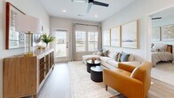 Located at 1650 Harris Hill Rd in San Marcos, TX, this well-appointed two-bedroom, two-bathroom residence offers a thoughtfully designed single-floor layout with a clean, contemporary aesthetic. The open-concept kitchen and living area serves as the heart of the home, featuring white shaker cabinetry, granite countertops, a subway tile backsplash, stainless steel appliances, and a kitchen island with bar seating. Light wood-style flooring flows throughout the main living areas, complementing the neutral palette. A dedicated bar nook with open shelving and a bistro table adds a charming, functional touch adjacent to the kitchen. The living room is bright and welcoming, with large windows allowing abundant natural light, a ceiling fan, recessed lighting, and access to an exterior door. Both bedrooms are carpeted and well-lit by natural light, with the primary bedroom offering a spacious walk-in closet outfitted with wire shelving. The bathrooms feature granite-topped vanities, white cabinetry, and wood-look flooring. A dedicated in-unit laundry room houses a full-size washer and dryer with overhead shelving. The overall ambiance is modern, clean, and comfortable throughout.