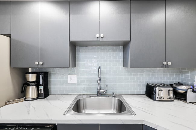 Kitchen w/tiled backsplash - 8481 Bumble Bee Way