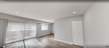 This recently renovated 780 square foot single-story home in Fairfax, VA, showcases a harmonious blend of modern design and functional living spaces. The property features two bedrooms, including a spacious primary bedroom of 190 square feet, and an open-concept kitchen and living room area.

Throughout the home, light wood-toned vinyl flooring creates a warm and inviting atmosphere, complemented by soft gray walls and crisp white trim. Recessed lighting fixtures provide ample illumination, while large windows and sliding glass doors allow natural light to flood the interior, casting beautiful shadow patterns across the floors.

The kitchen boasts stainless steel appliances, dark wood cabinetry, and granite countertops, offering both style and functionality. A pass-through window opens to the living area, enhancing the open-concept feel. The living room is spacious and bright, with ample room for comfortable seating and entertainment options.

Both bedrooms feature sizable windows with horizontal blinds, allowing for privacy and light control. Built-in closets with paneled doors provide generous storage space. The primary bedroom's 190 square feet offers plenty of room for a king-sized bed and additional furniture.

This home's thoughtful renovation emphasizes clean lines, neutral tones, and an overall contemporary aesthetic, creating a move-in ready space that balances modern living with cozy comfort.